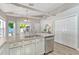 Bright kitchen with stainless steel appliances, white cabinets, and a breakfast nook, creating a cheerful cooking space at 441 S Blue Lake Ave, Deland, FL 32724