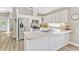 White kitchen with stainless steel appliances, modern countertops, and ample cabinet space at 441 S Blue Lake Ave, Deland, FL 32724