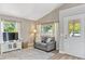 Comfortable living room featuring a gray couch, large windows with bright light, and modern flooring at 441 S Blue Lake Ave, Deland, FL 32724