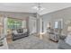 Bright living room featuring a grey sofa set, a ceiling fan and an entrance door in a modern-styled home at 441 S Blue Lake Ave, Deland, FL 32724