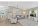 Cozy living room with a gray couch, recliner, wood laminate flooring, vaulted ceilings, and a TV on console at 441 S Blue Lake Ave, Deland, FL 32724