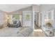 Bright living room featuring vaulted ceilings, wood flooring, with entry door, and a view of the house at 441 S Blue Lake Ave, Deland, FL 32724