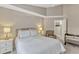 Main bedroom features bedside tables and lamps, carpet, ceiling fan, and neutral paint at 441 S Blue Lake Ave, Deland, FL 32724