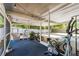 View of the screened in porch with string lights, comfortable seating, and exercise equipment at 441 S Blue Lake Ave, Deland, FL 32724
