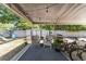 View of the screened in porch with string lights and comfortable seating at 441 S Blue Lake Ave, Deland, FL 32724