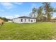 The home's backyard features a large lawn and an exterior view of the house at 443 Marion Oaks Crse, Ocala, FL 34473