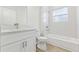 Clean bathroom with a vanity, toilet, and tub-shower combination with tiled walls at 443 Marion Oaks Crse, Ocala, FL 34473
