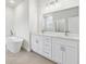 Bright bathroom featuring a double vanity, a soaking tub, and a large mirror at 443 Marion Oaks Crse, Ocala, FL 34473