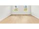 Empty bedroom with wood-look floors, natural light, and a serene view at 443 Marion Oaks Crse, Ocala, FL 34473