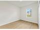 Cozy bedroom featuring light wood flooring and a window view at 443 Marion Oaks Crse, Ocala, FL 34473