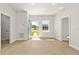 A bright entryway with an open door and laminate floors, providing a welcoming view at 443 Marion Oaks Crse, Ocala, FL 34473