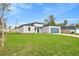 View of a well-maintained home with a green lawn, painted in neutral colors and a blue garage door at 443 Marion Oaks Crse, Ocala, FL 34473