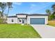 Charming single-Gathering home with a well-manicured lawn, blue accents, and a two-car garage at 443 Marion Oaks Crse, Ocala, FL 34473