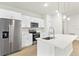 Modern kitchen with stainless steel appliances, quartz countertops, and white cabinetry at 443 Marion Oaks Crse, Ocala, FL 34473