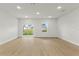 Spacious living room with light wood flooring, natural light, and backyard access at 443 Marion Oaks Crse, Ocala, FL 34473