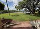 Scenic backyard view featuring lush green grass, mature trees, and a tranquil lake at 510 Cranes Way # 105, Altamonte Springs, FL 32701
