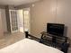 Inviting bedroom with a comfortable bed, TV, and French doors leading to another room at 510 Cranes Way # 105, Altamonte Springs, FL 32701