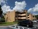 Tan two-story condo with balconies and well-maintained landscaping near marked parking spot at 510 Cranes Way # 105, Altamonte Springs, FL 32701