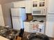 Efficient kitchen features white appliances, plenty of cabinet space, and ample counter area at 510 Cranes Way # 105, Altamonte Springs, FL 32701