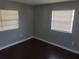 Bedroom with dark hardwood floors, light gray walls, and natural light provided by exterior windows at 539 Clark St, Maitland, FL 32751