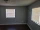 Bedroom with dark hardwood floors, light gray walls, and natural light provided by exterior windows at 539 Clark St, Maitland, FL 32751