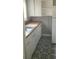 Compact kitchen with a stainless steel sink, light-colored cabinets, and unique patterned flooring at 539 Clark St, Maitland, FL 32751