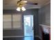 Cozy living room with a red brick fireplace, ceiling fan, and natural light from the exterior at 539 Clark St, Maitland, FL 32751