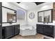 A luxurious bathroom with dual vanities, a soaking tub, and modern finishes at 572 Lanarkshire Pl, Apopka, FL 32712