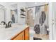 Well-lit bathroom featuring a single sink vanity, toilet, and shower with a decorative shower curtain at 572 Lanarkshire Pl, Apopka, FL 32712
