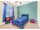 Colorful bedroom decorated with themed bedding, curtains and a Spiderman chair at 572 Lanarkshire Pl, Apopka, FL 32712