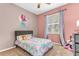 Charming bedroom featuring pink walls, a decorative mermaid wall art, and a bright window at 572 Lanarkshire Pl, Apopka, FL 32712