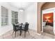 Bright dining area with a modern table set and view to the bedroom through an arched entryway at 572 Lanarkshire Pl, Apopka, FL 32712
