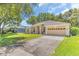 Charming single-story home featuring a manicured lawn, two-car garage, and welcoming front entrance at 572 Lanarkshire Pl, Apopka, FL 32712