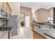 Well-equipped kitchen with stainless steel appliances and ample counter space, flowing into the dining and living areas at 572 Lanarkshire Pl, Apopka, FL 32712