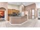 Open kitchen features wood cabinets, stainless steel appliances, and a breakfast bar overlooking the living area at 572 Lanarkshire Pl, Apopka, FL 32712