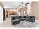 Open-concept living area with a large sectional sofa, ceiling fan, and tile flooring throughout at 572 Lanarkshire Pl, Apopka, FL 32712