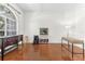 Bright room with sleek hardwood floors, a large window, and versatile furniture arrangement options at 572 Lanarkshire Pl, Apopka, FL 32712