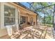 Covered and screened patio area with a grill and seating, perfect for entertaining at 572 Lanarkshire Pl, Apopka, FL 32712