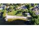 Aerial view of a charming lakeside park with a sandy beach, playground, and picnic area at 604 Blue Lake Dr, Longwood, FL 32779