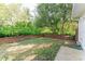 Private backyard featuring a brick retaining wall and lush greenery at 604 Blue Lake Dr, Longwood, FL 32779