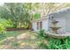 Lush backyard with a fountain and access to the house via French doors at 604 Blue Lake Dr, Longwood, FL 32779