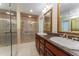 Elegant bathroom with double vanity, granite counters, and glass-enclosed shower at 604 Blue Lake Dr, Longwood, FL 32779