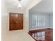 Bright foyer with a double door and tile flooring leading to a living area with wood floors and plantation shutters at 604 Blue Lake Dr, Longwood, FL 32779