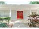 Inviting front entrance of home featuring a red double door and manicured landscaping at 604 Blue Lake Dr, Longwood, FL 32779