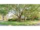 Beautiful single-story home with a large front yard, mature trees, and well-maintained landscaping at 604 Blue Lake Dr, Longwood, FL 32779