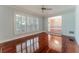 Light-filled living room with wood flooring, plantation shutters, and neutral paint, offering an open flow to the dining room at 604 Blue Lake Dr, Longwood, FL 32779