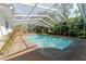A fenced-in pool and patio deck are surrounded by the privacy of lush greenery at 604 Blue Lake Dr, Longwood, FL 32779