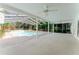 An empty pool area and covered patio offer shade and space for outdoor gatherings at 604 Blue Lake Dr, Longwood, FL 32779