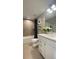 Well-lit bathroom with a modern vanity, bathtub, and decorative shelving at 6450 Horseshoe Lane Way, St Cloud, FL 34773