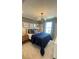 Nicely decorated bedroom with unique art, a comfortable bed, and a modern ceiling fan at 6450 Horseshoe Lane Way, St Cloud, FL 34773
